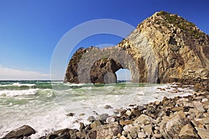 Natural arch on the rocky coastline of Izu Peninsula, Japan photo